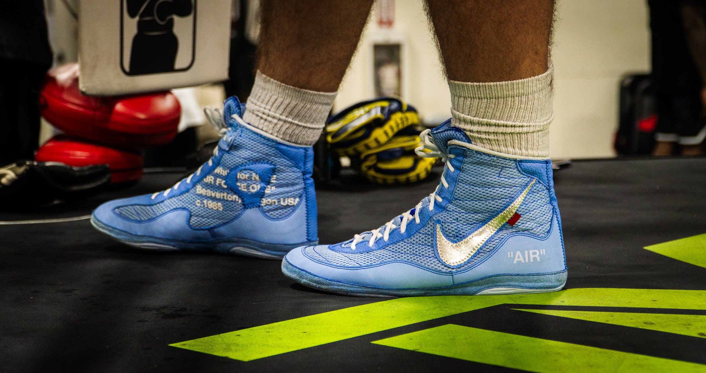 Blue boxing shoes on the gym mat
