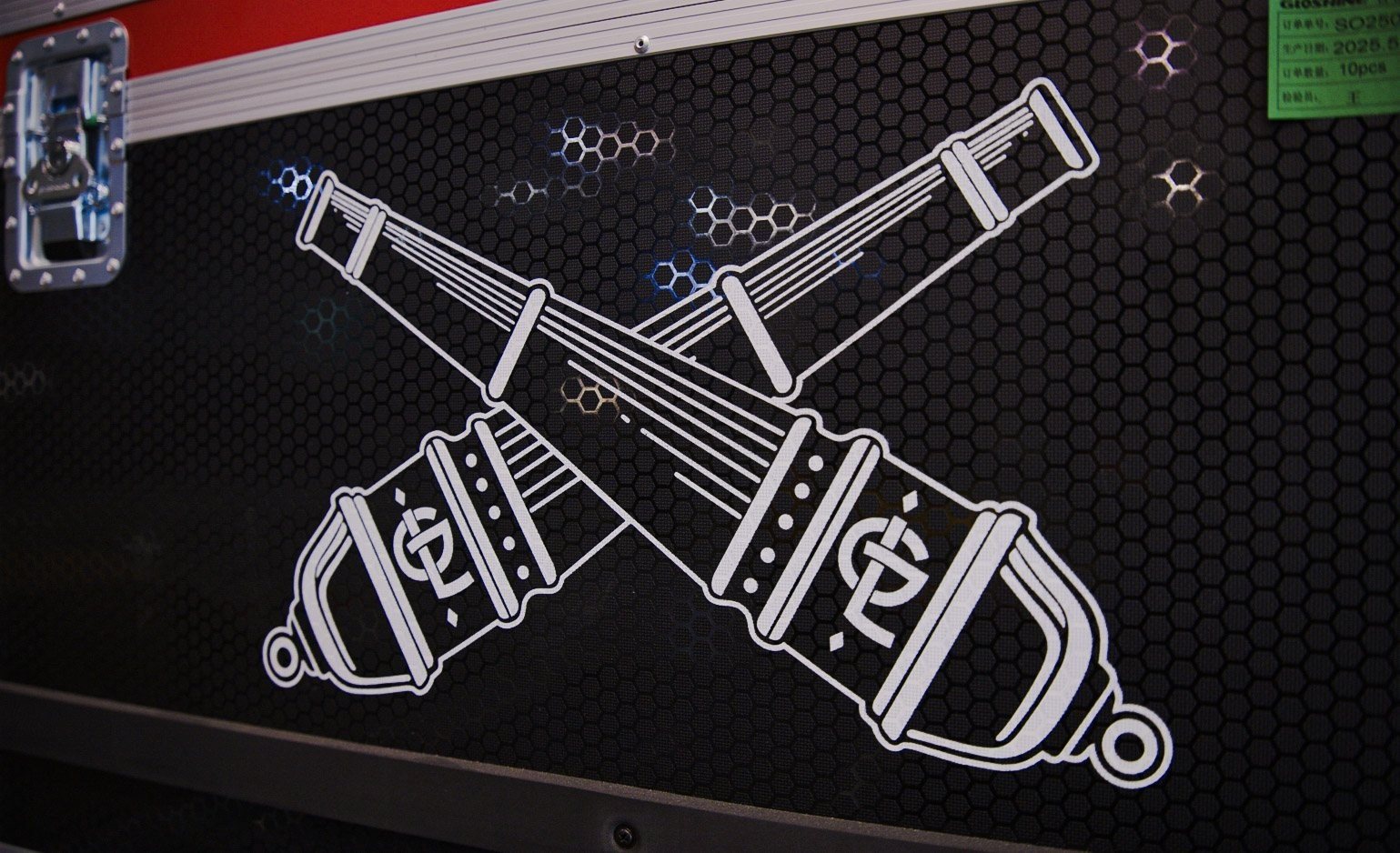 Road case stenciled with a crossed-tools logo