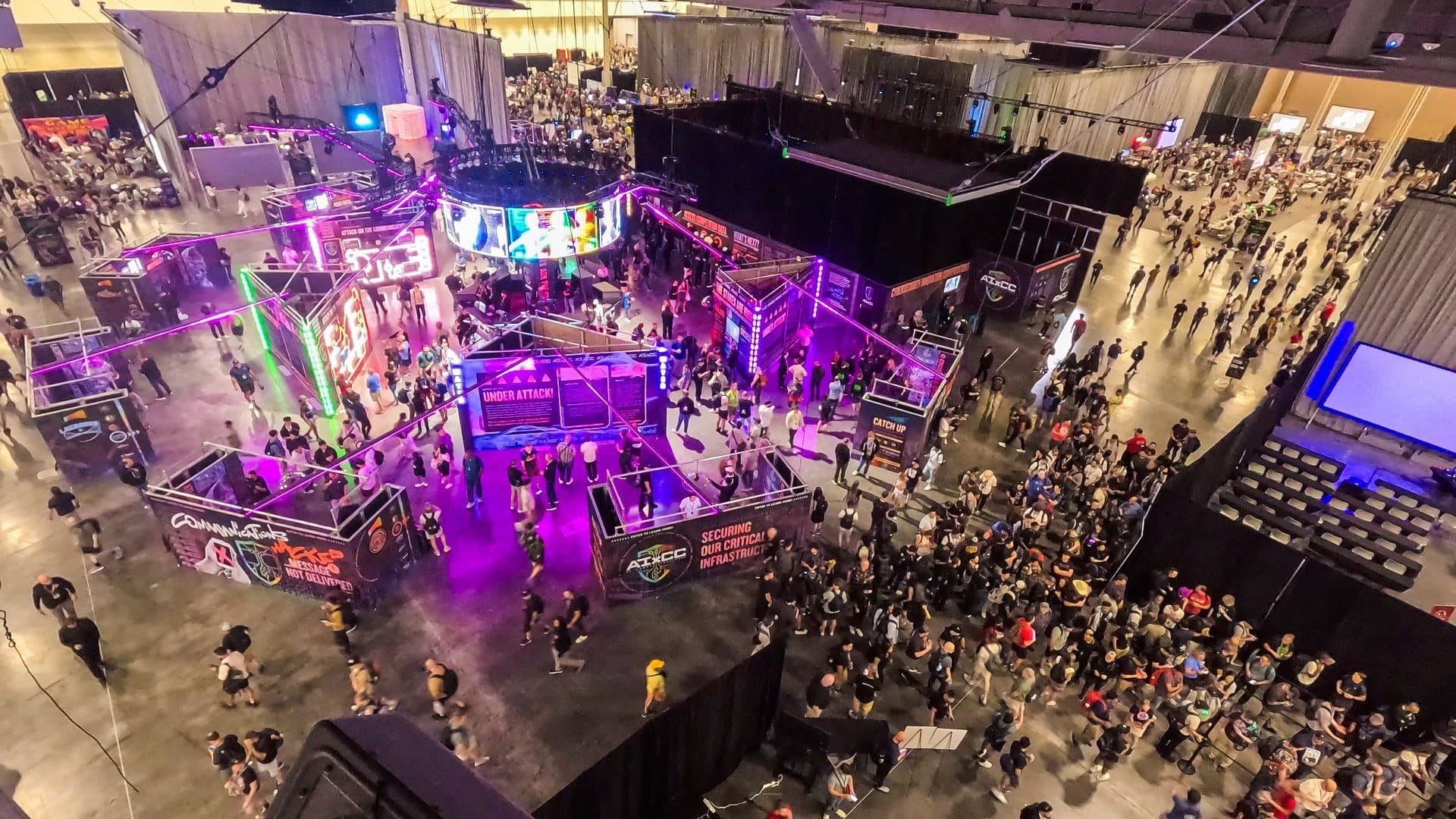 Aerial of the crowd around DefCon's main stage under purple light