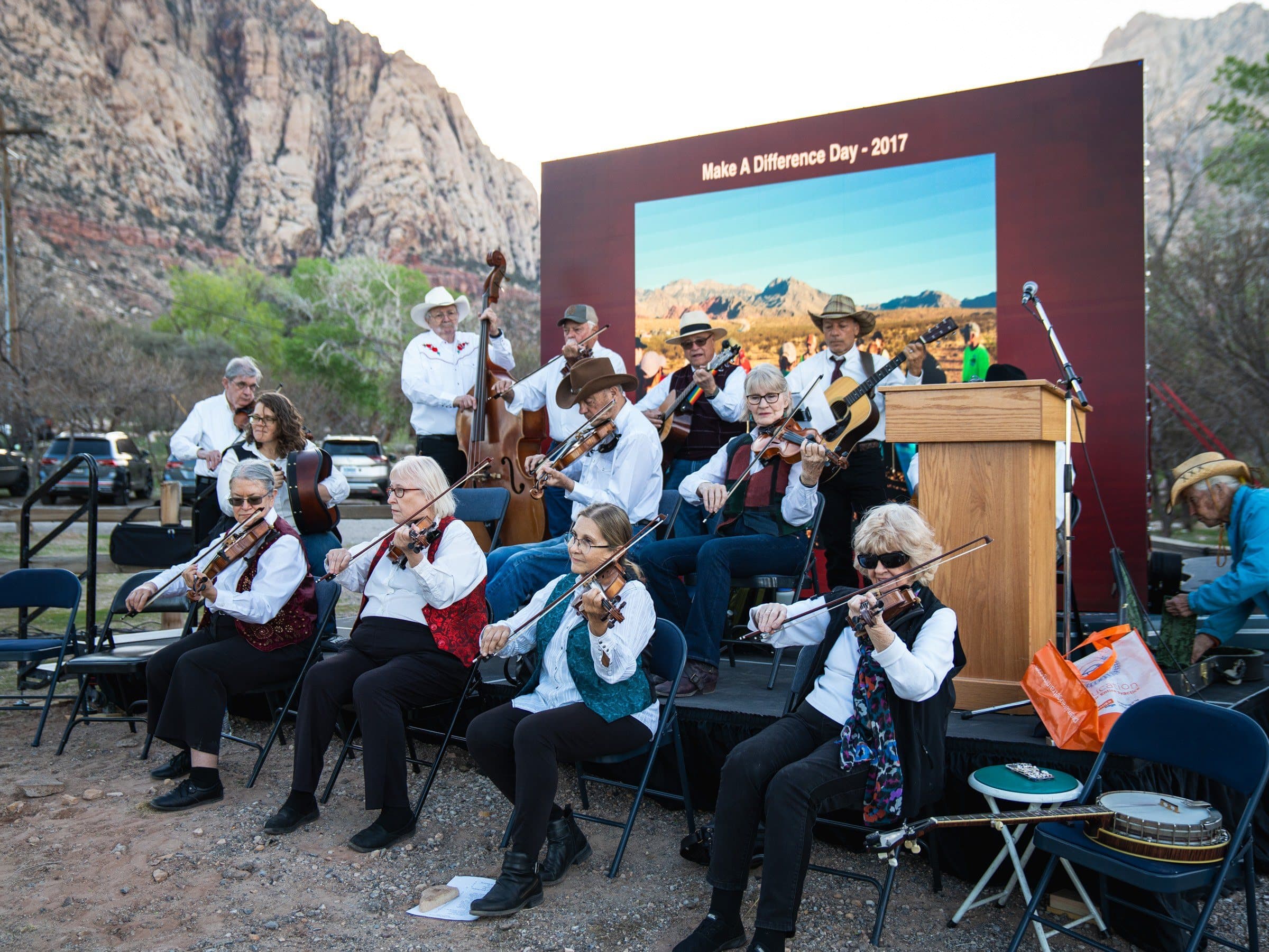 Fiddle orchestra performing beneath the canyon walls