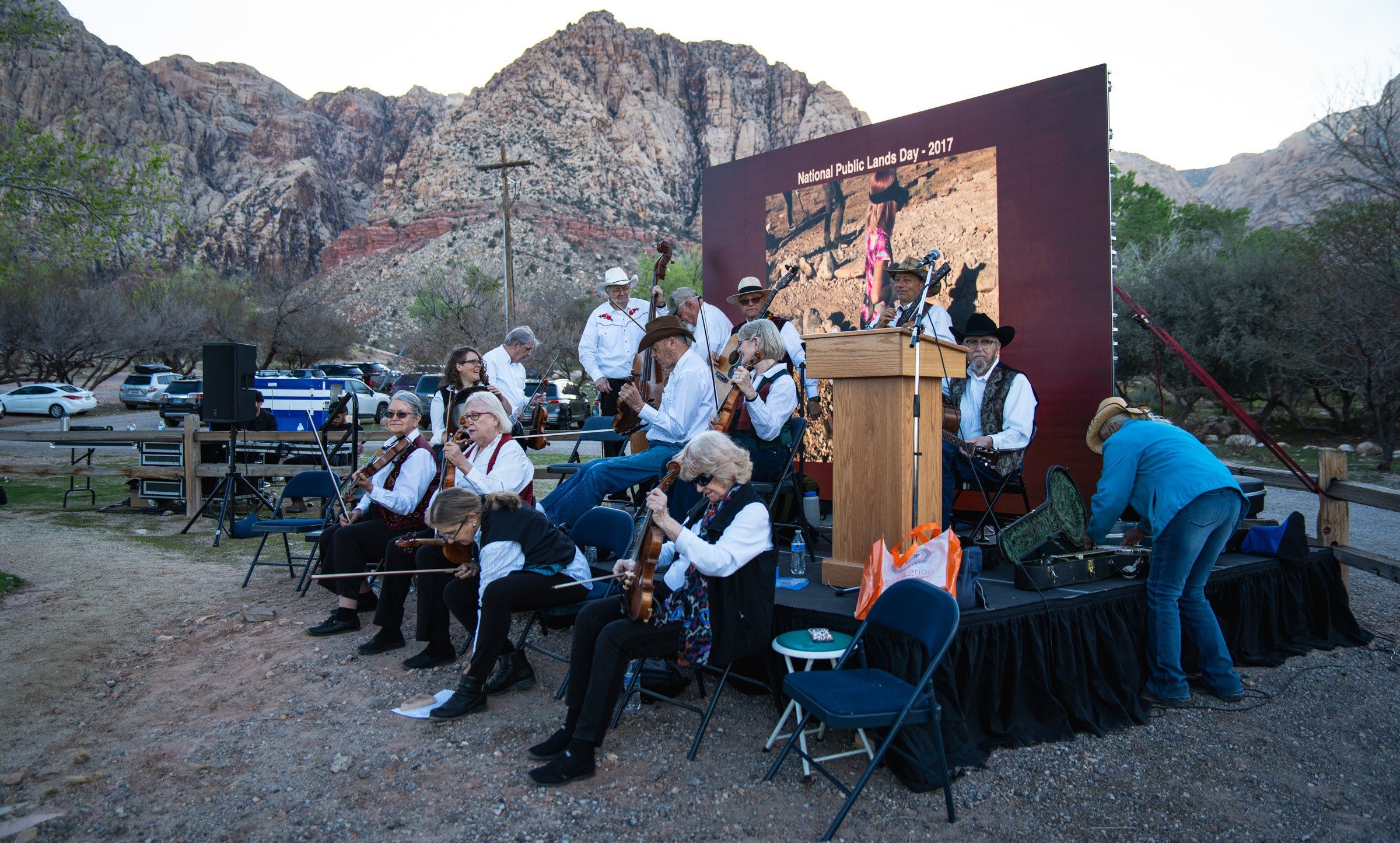 Wide of the orchestra and stage under Red Rock's peaks
