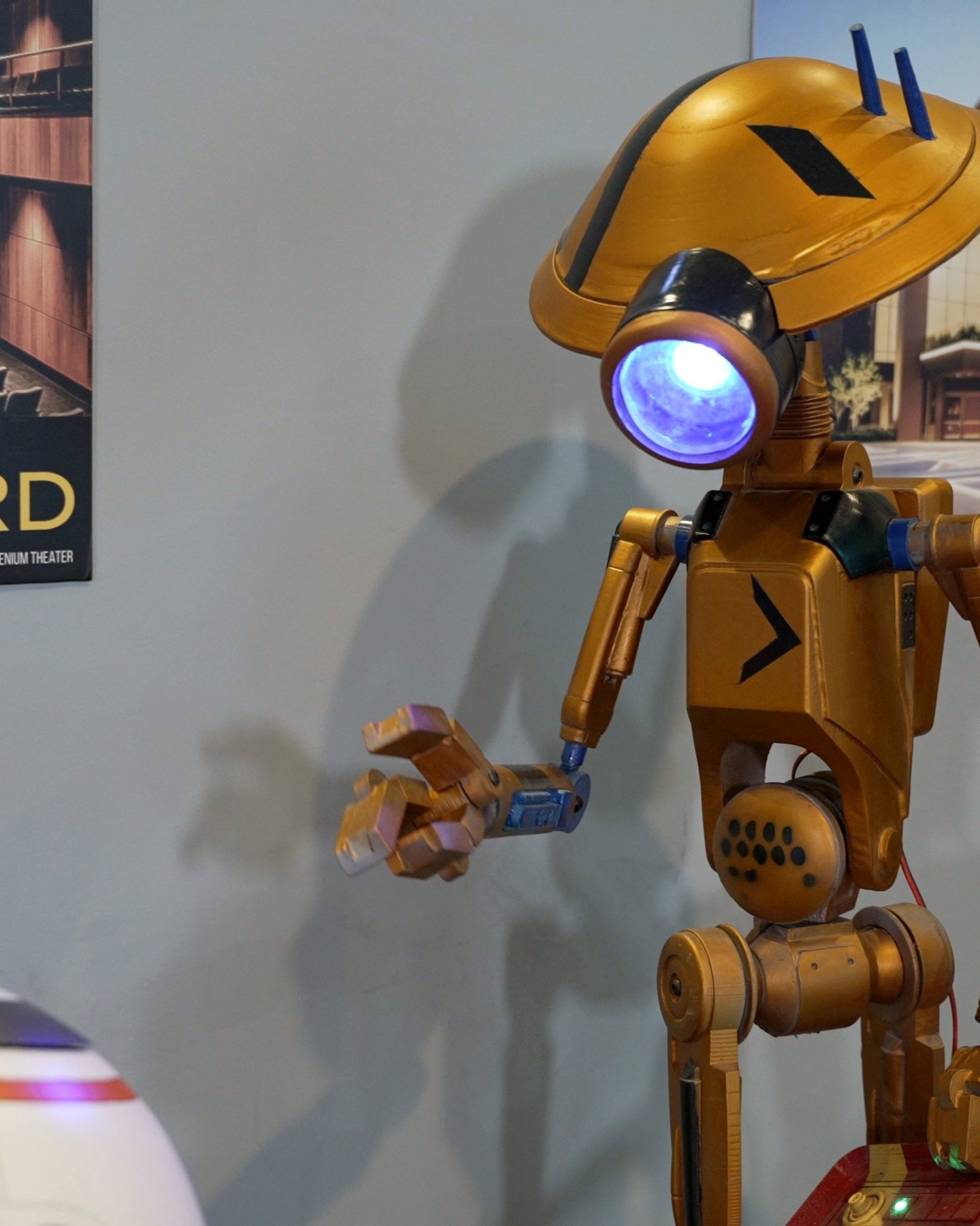 Gold droid prop greeting guests on the red carpet