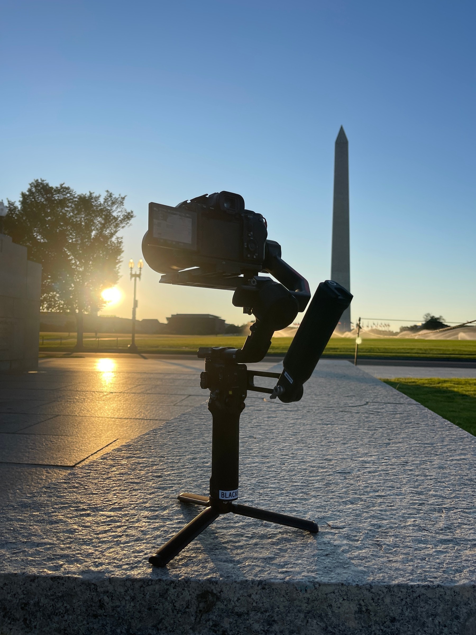 Gimbal rig silhouetted against the Washington Monument at sunrise