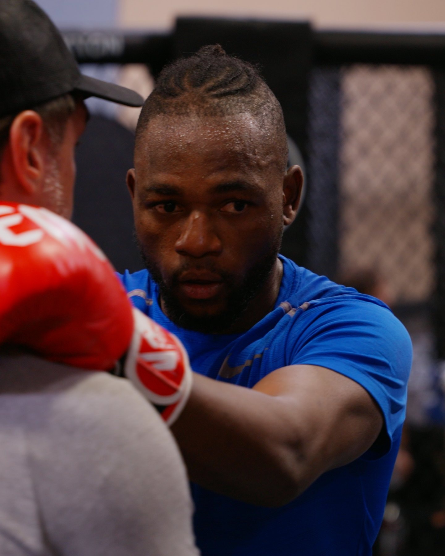 Kape throwing a jab into his coach's pads