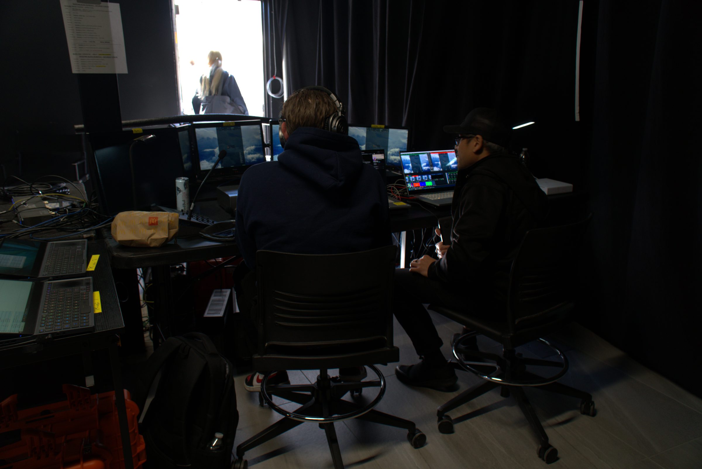 Operators at their stations in the production control room