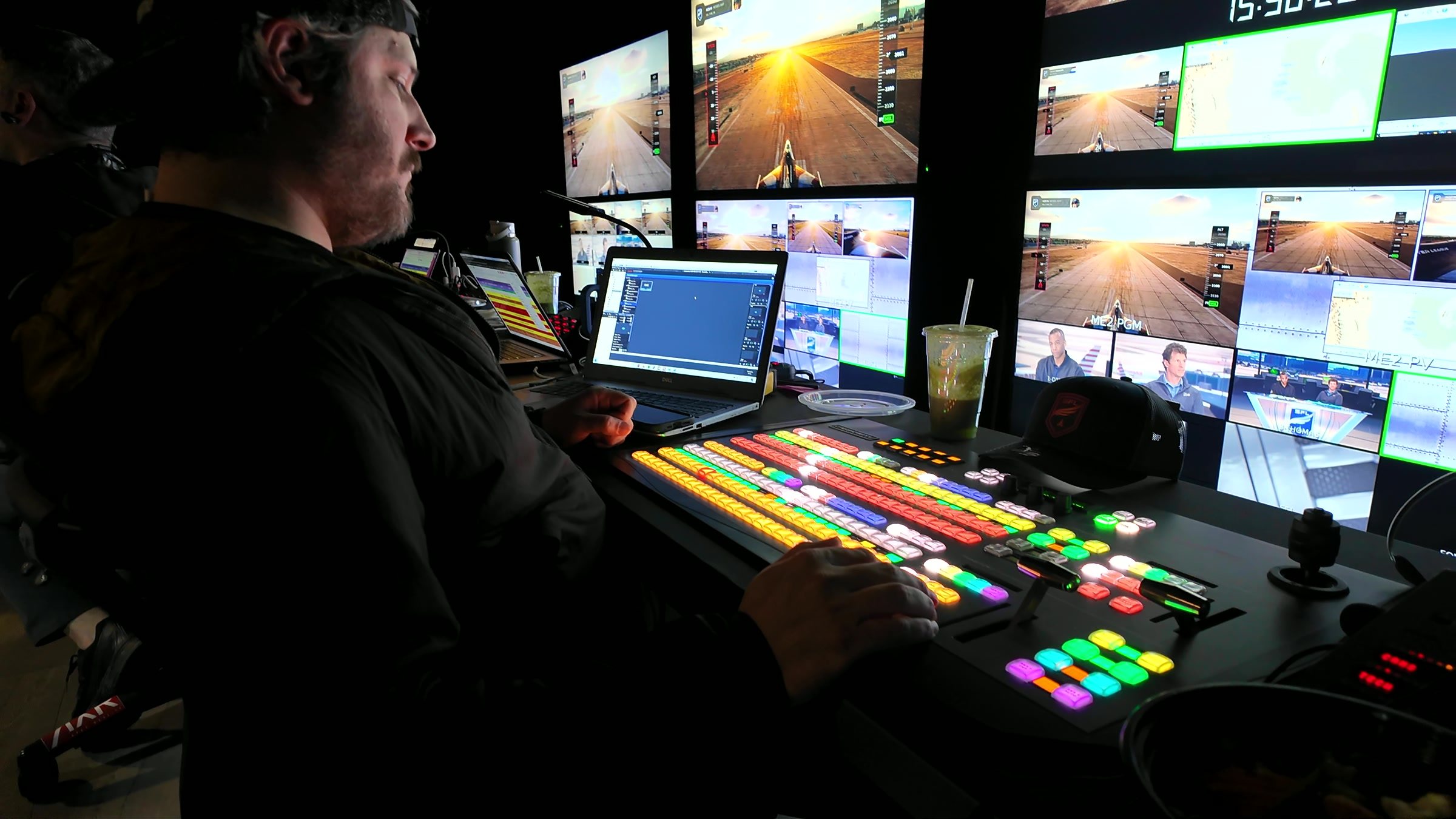 Technical director at a lit-up switcher in the live control room