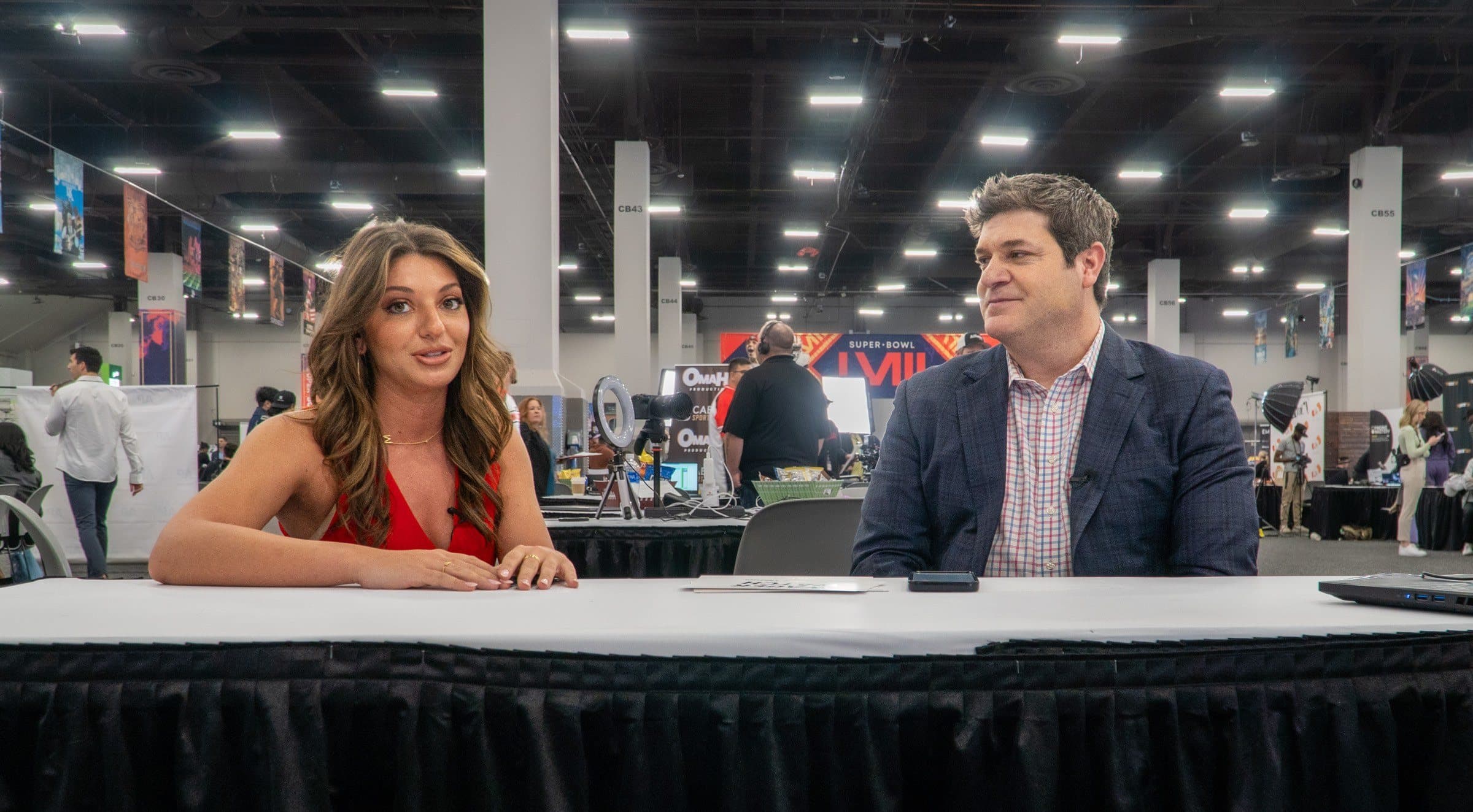 Two hosts at a Radio Row table during Super Bowl week